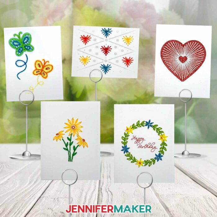 Learn how to make Paper Embroidery Cards! A collection of embroidered cards with butterflies, hearts, and flowers sits on display on an outdoor wooden table