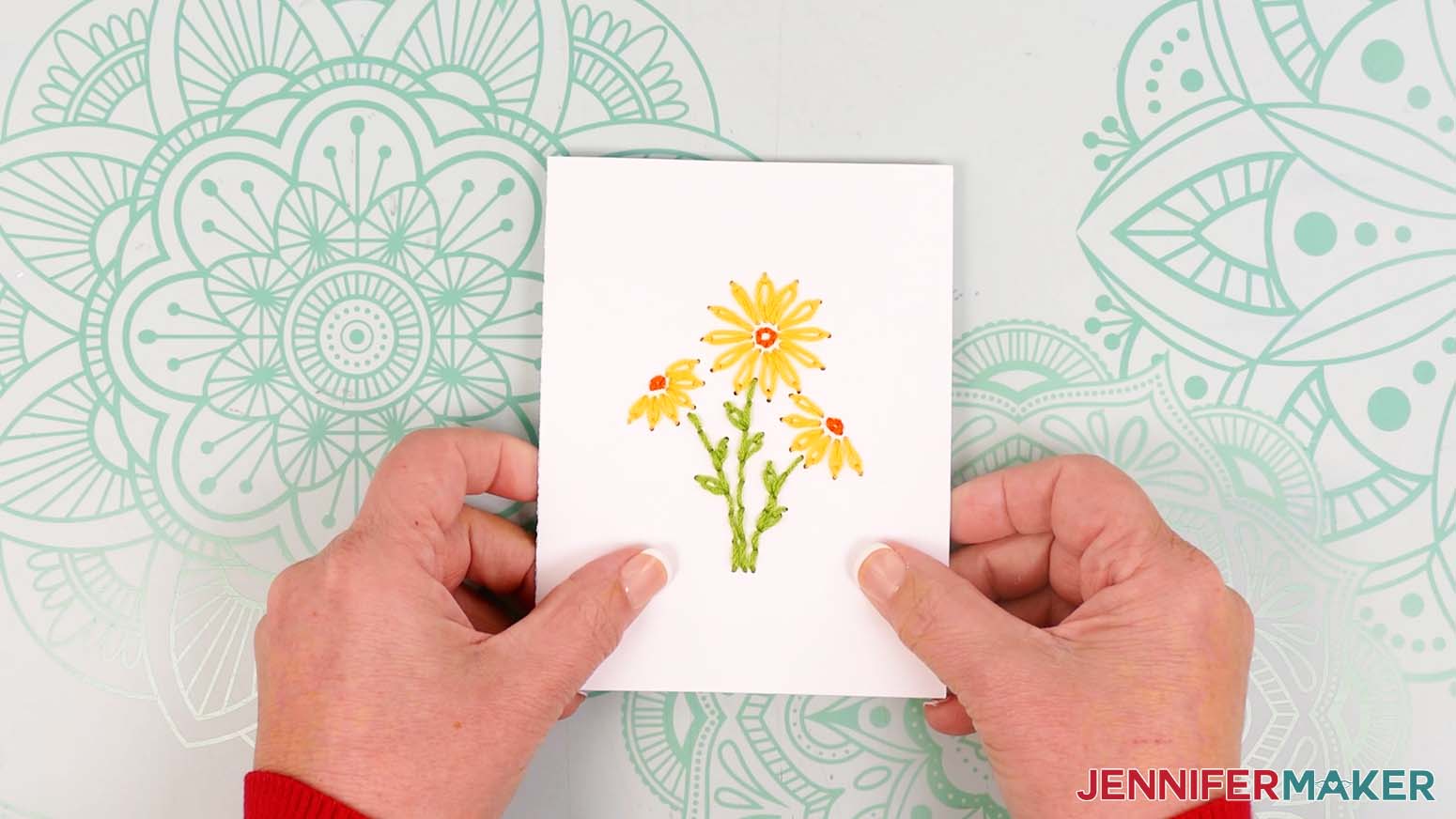 Finished paper embroidery card with daisy design.