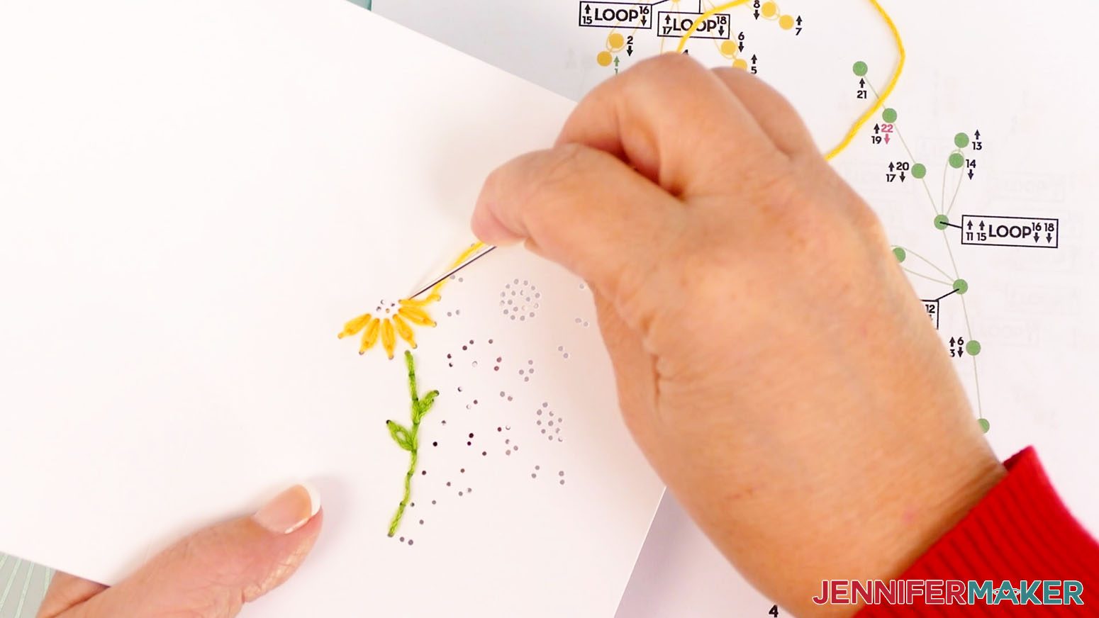 Insert the needle down through hole 24 to finish the last petal on the left daisy paper embroidery design.