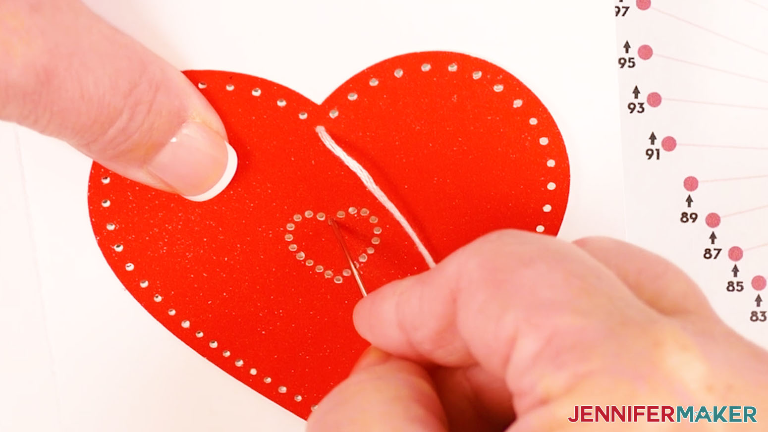 Pull the white embroidery floss through hole one and insert the needle down through hole two.