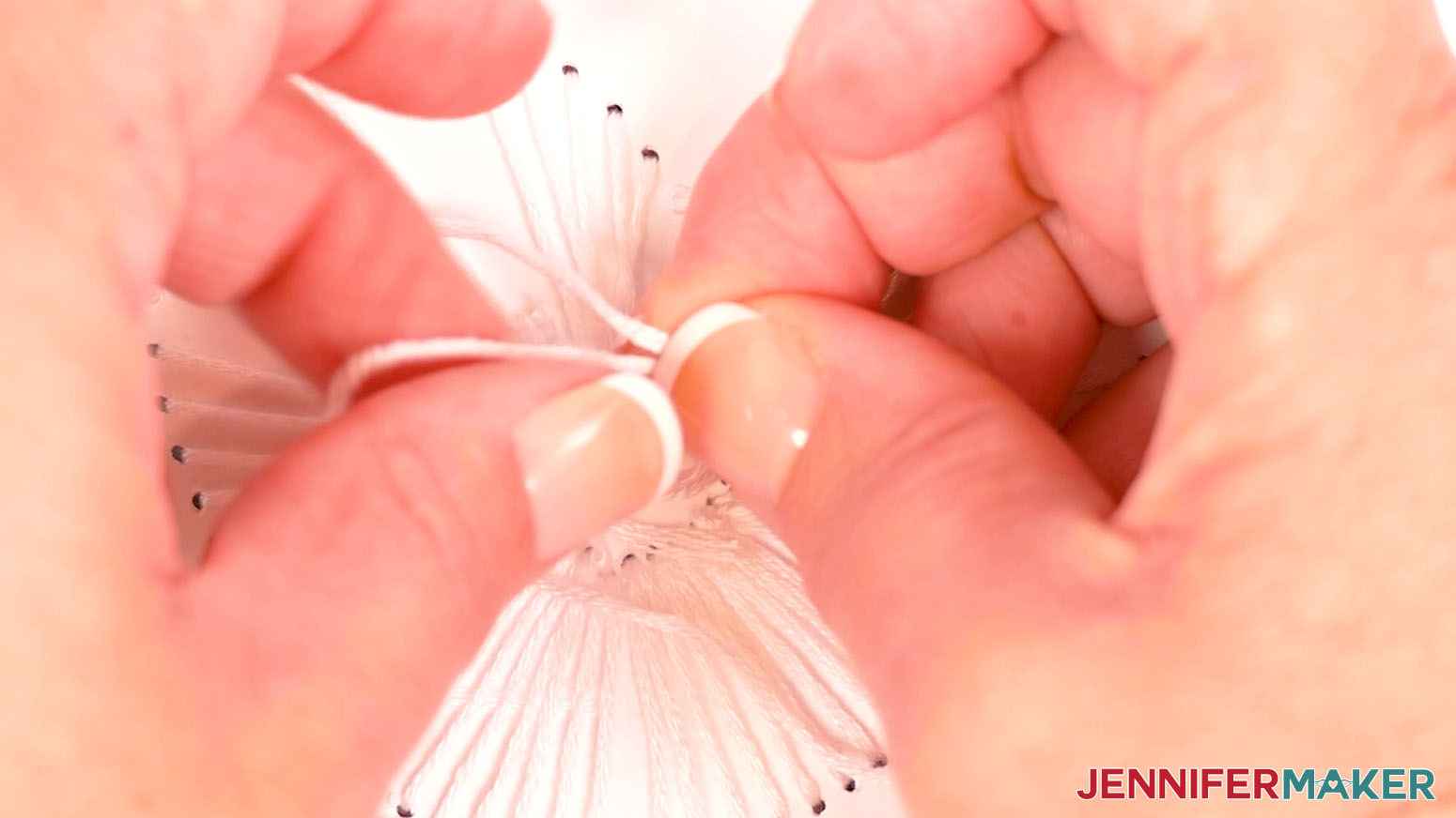Carefully tie a knot on the back side of the card to secure the embroidery floss.