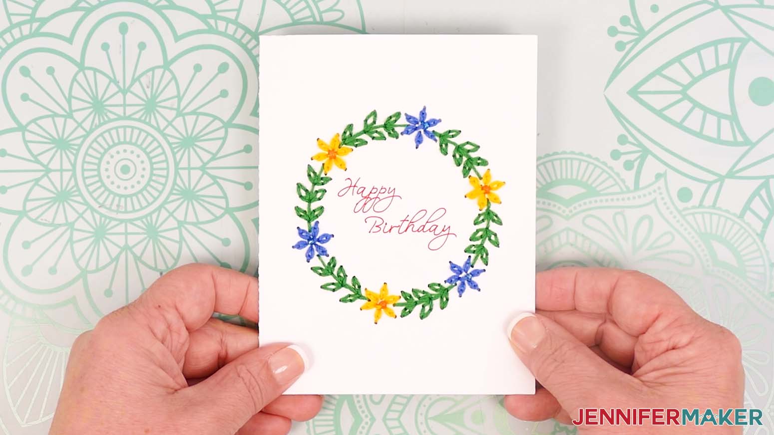 Continue with the same steps for each section of leaves to complete the floral wreath embroidered card design.