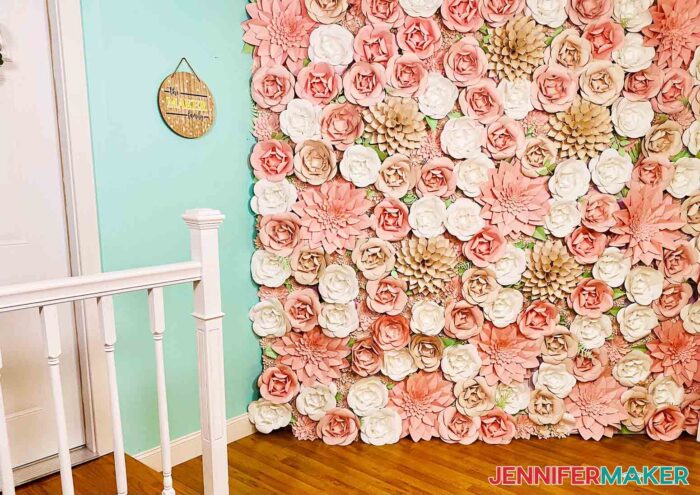 Pink and white Paper Flower Backdrop in a room with blue walls