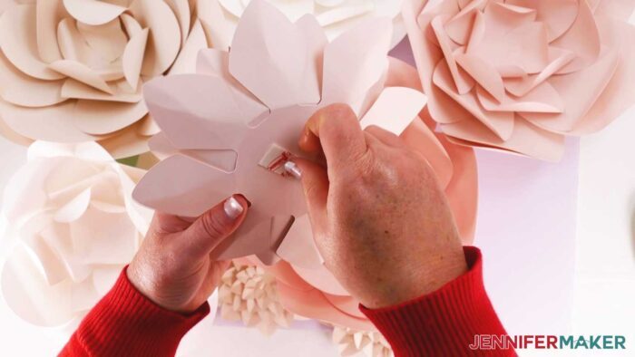 Apply 3M Command Strips for poster hanging on the back of each flower for the paper flower backdrop.