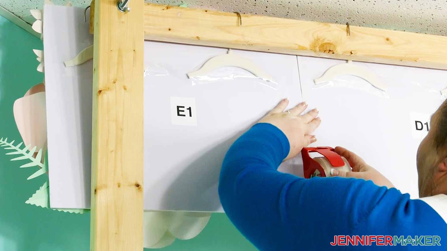 Use clear packing tape to join the paper flower backdrop panels along the seams from the back.