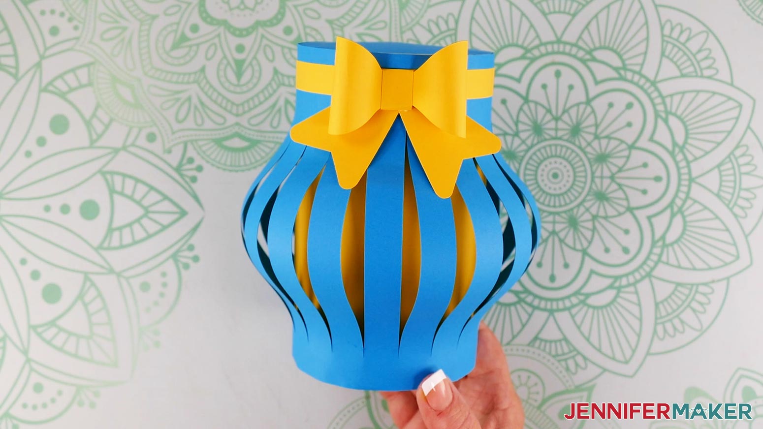 Attach the assembled bow to the front of the finished paper flower bouquet vase