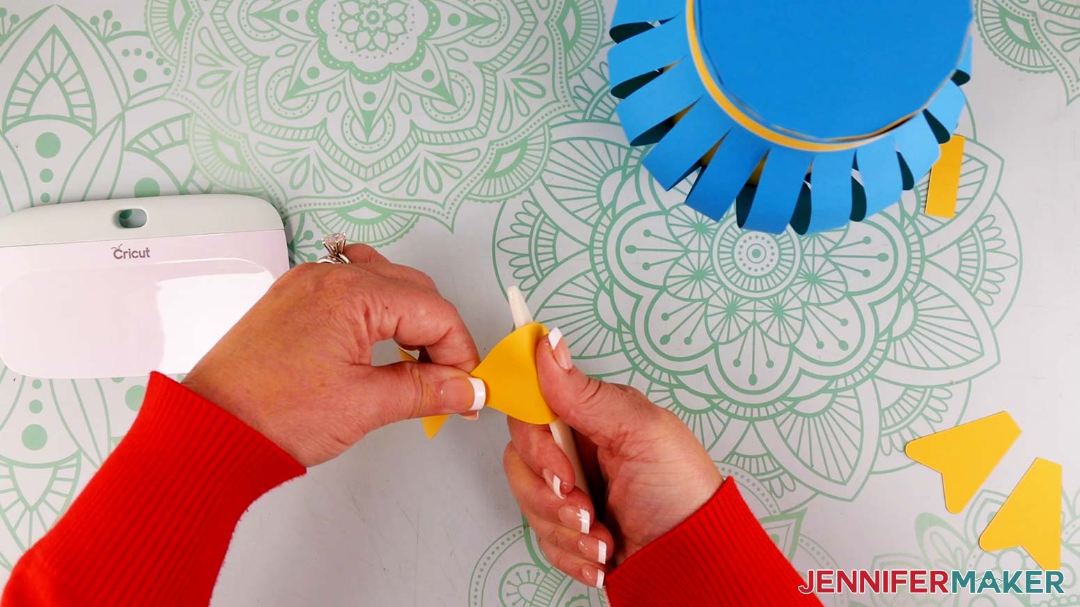 Use a bone folder to curve the cardstock loops for the paper flower bouquet bow