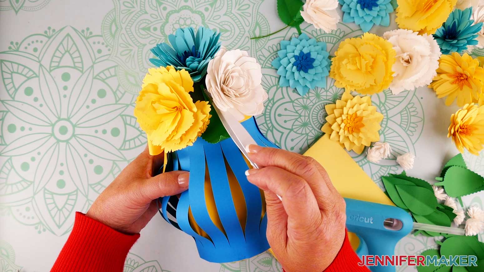 Use tweezers to attach the paper flower bouquet leaves to the foam hemisphere with hot glue