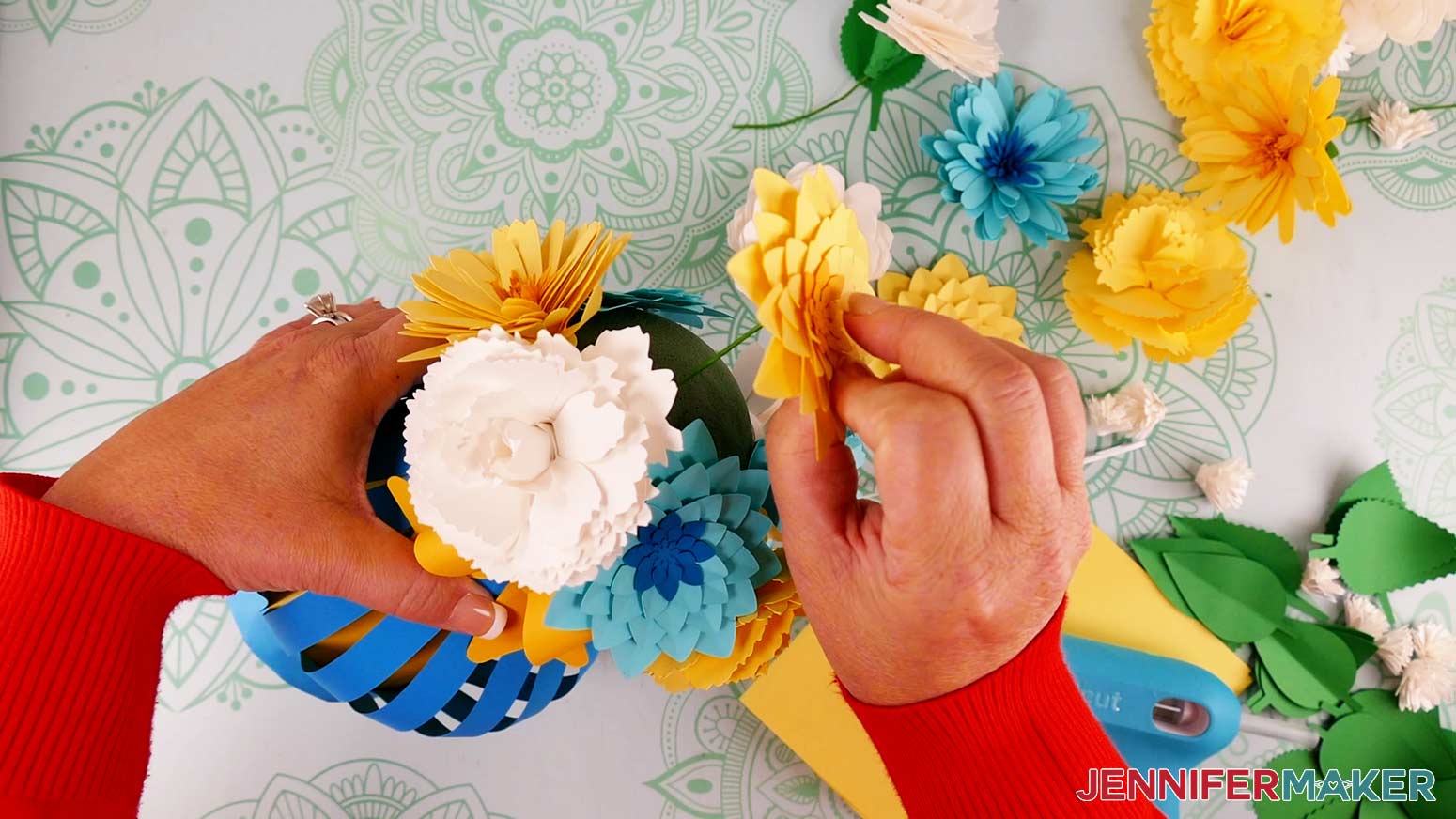Insert the free end of a paper flower stem into the foam hemisphere on the paper flower bouquet vase