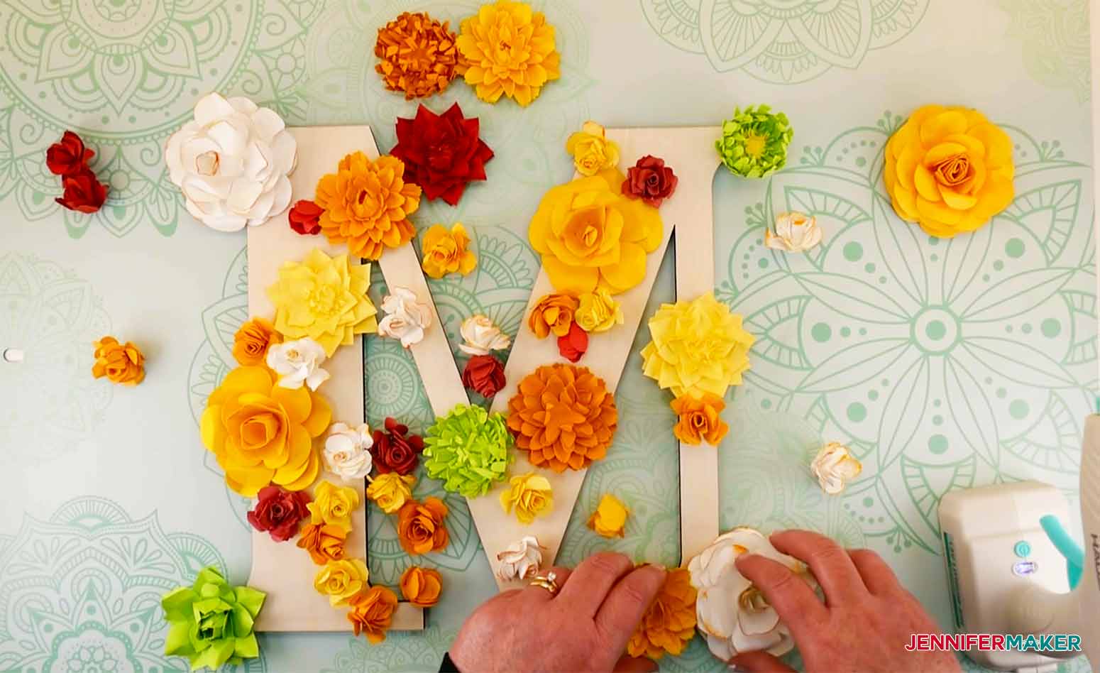 Ready to glue flowers in place on paper flower letter.