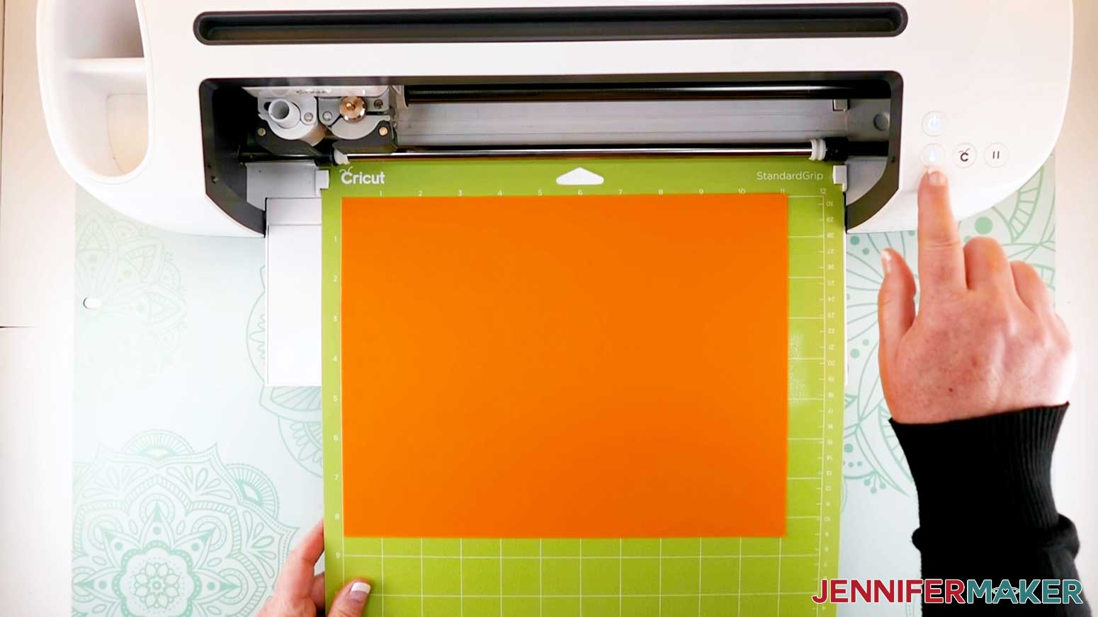 loading mat into cricut machine for the paper flower letter project