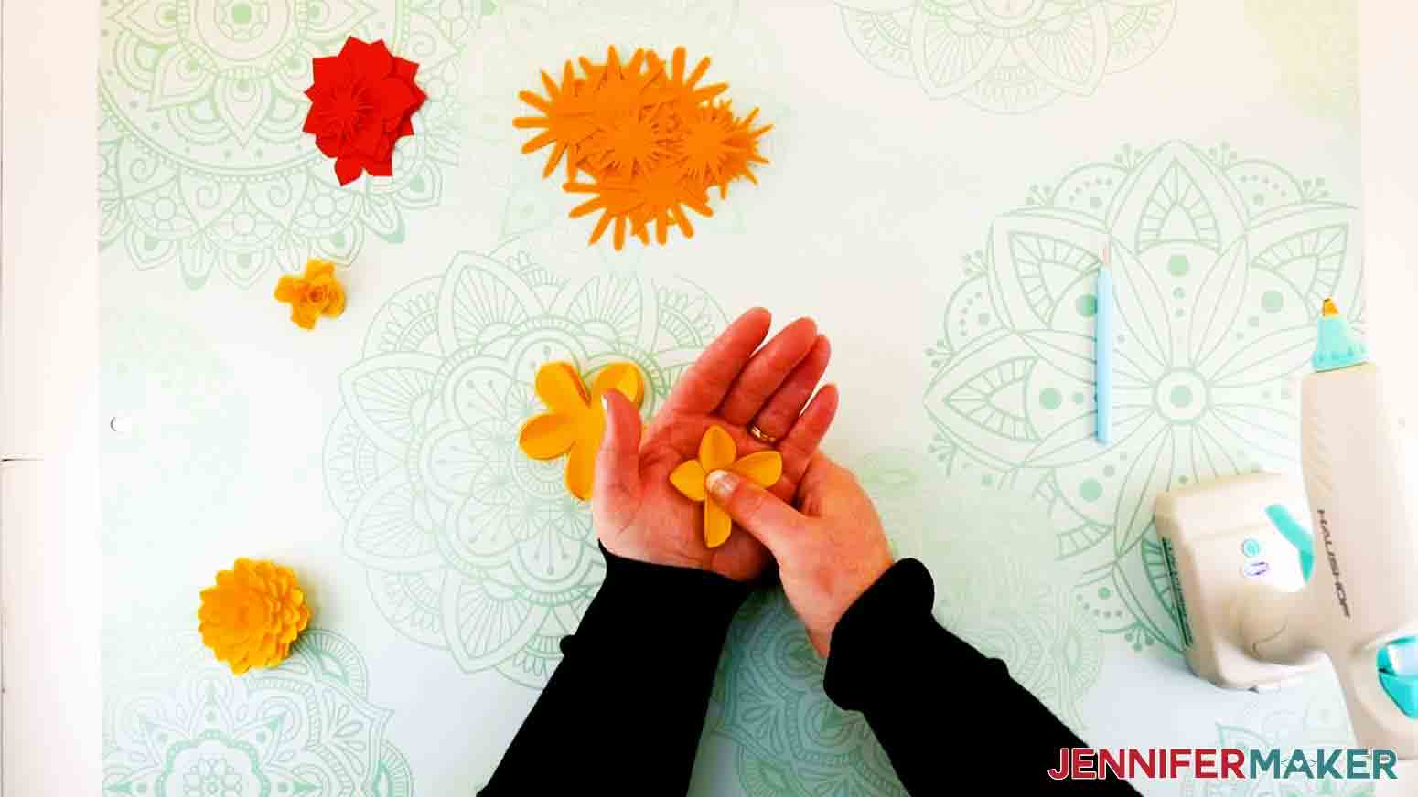 pushing petals into palm of a paper flower letter