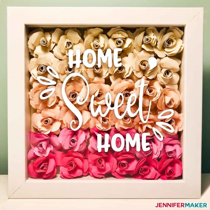 A pretty paper flower shadow box made from rolled paper roses