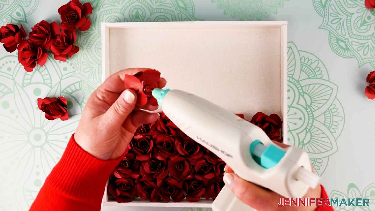 Continue gluing the paper flowers to the shadow box