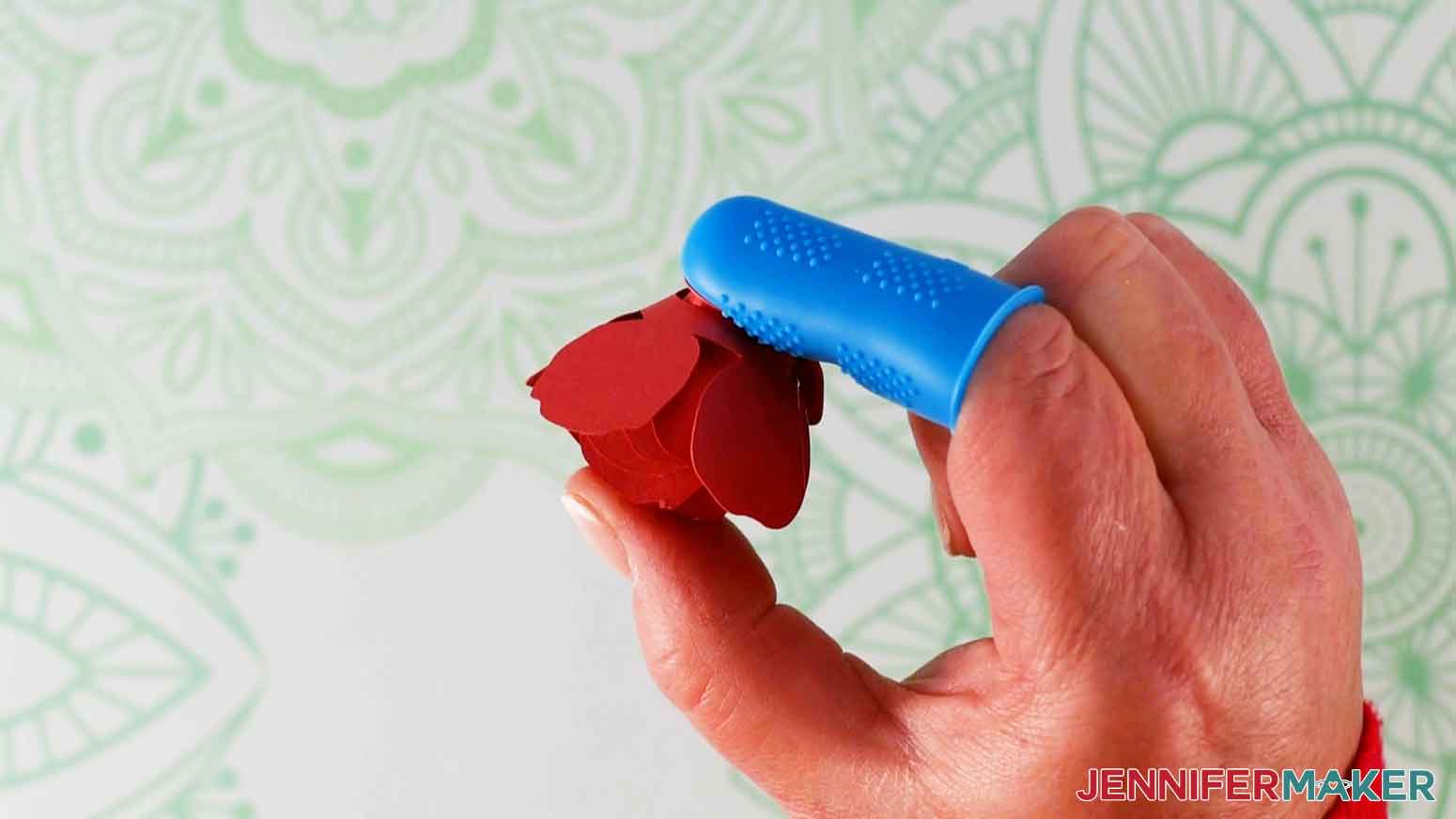 Press the tab on the hot glue to make the rose for my paper flower shadow box