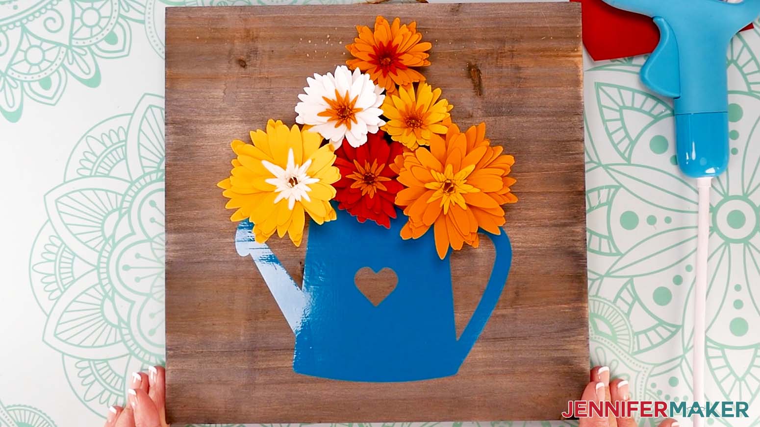 All daisies are glued in to place on the watering can sign.