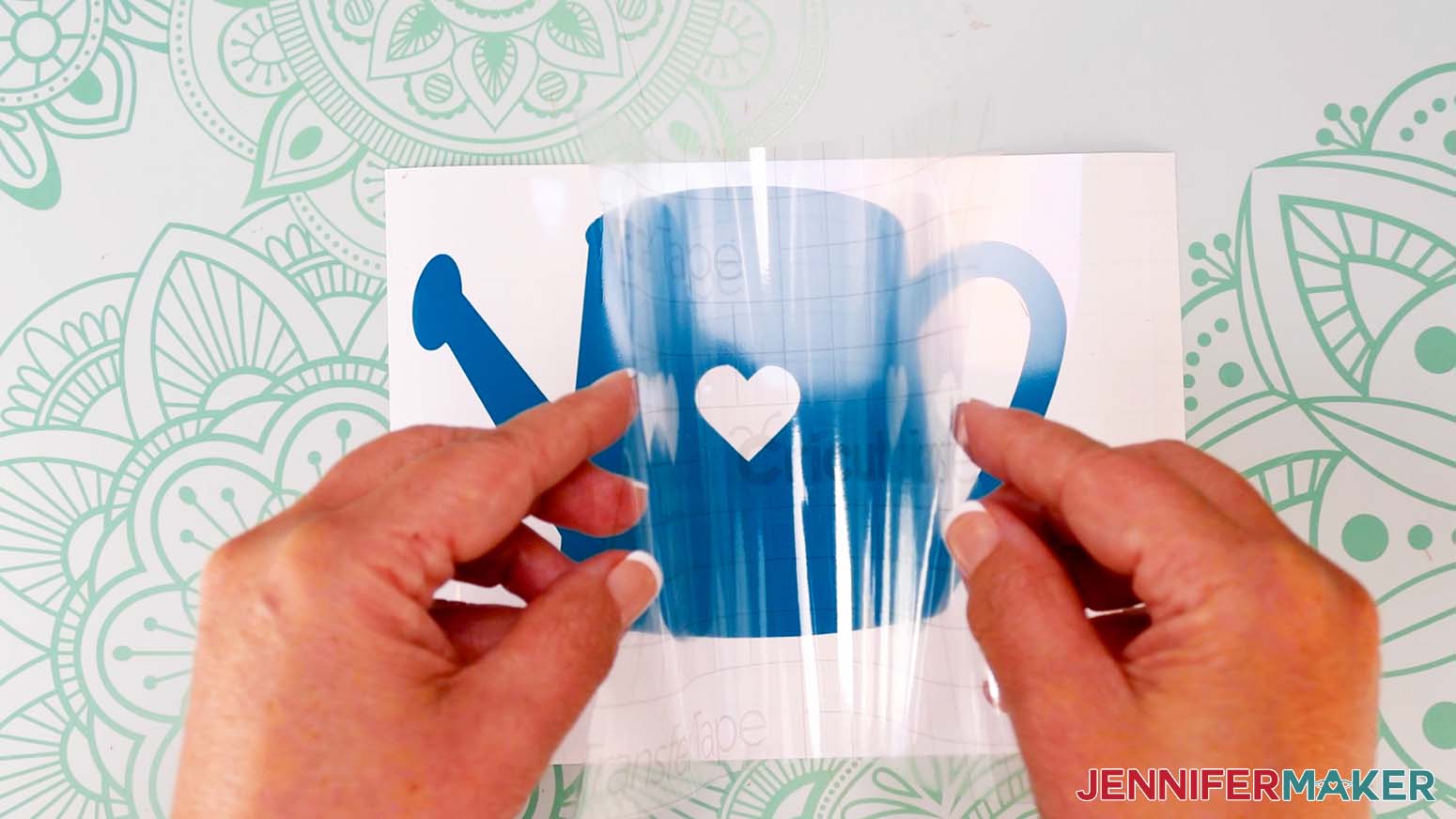 Fold the edges of the transfer tape up like a taco and lower the center on to the vinyl.
