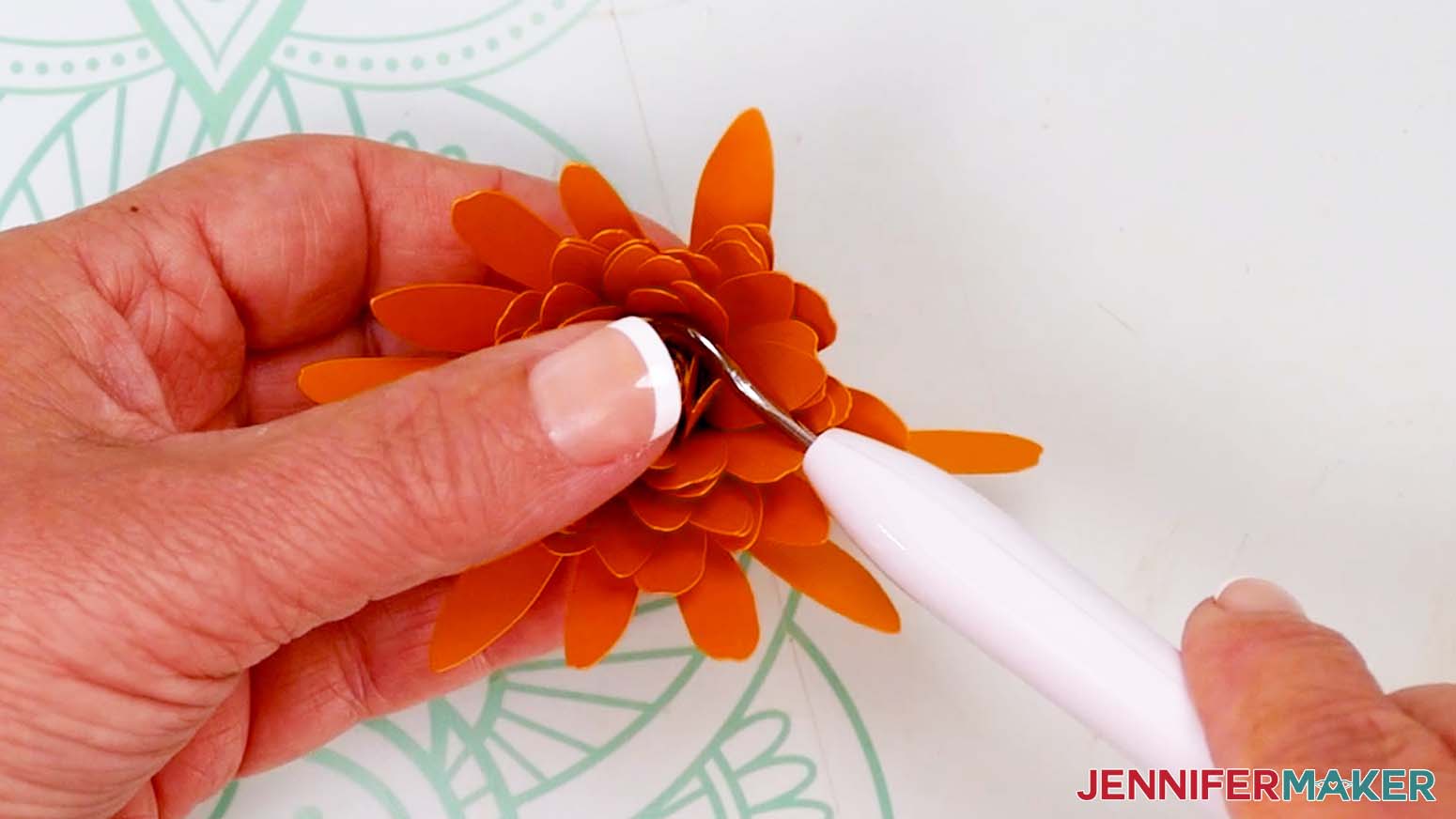 Use a weeding tool to loosen the center of the flower if rolled too tightly.