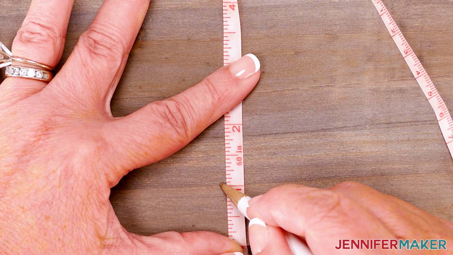 Use a measuring tape and pencil to mark the center of your sign.