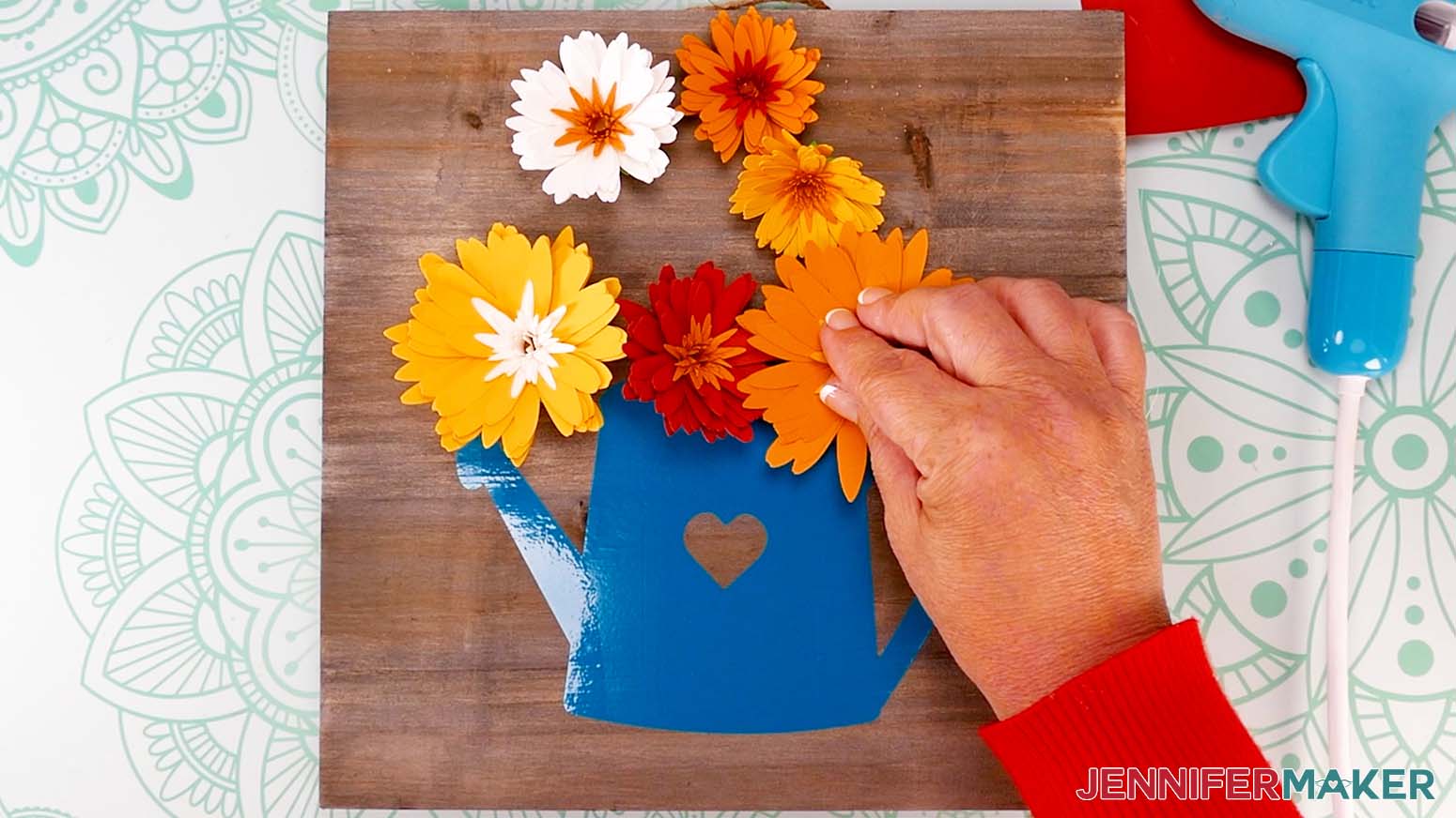 Press the flower against the sign to adhere the glue.