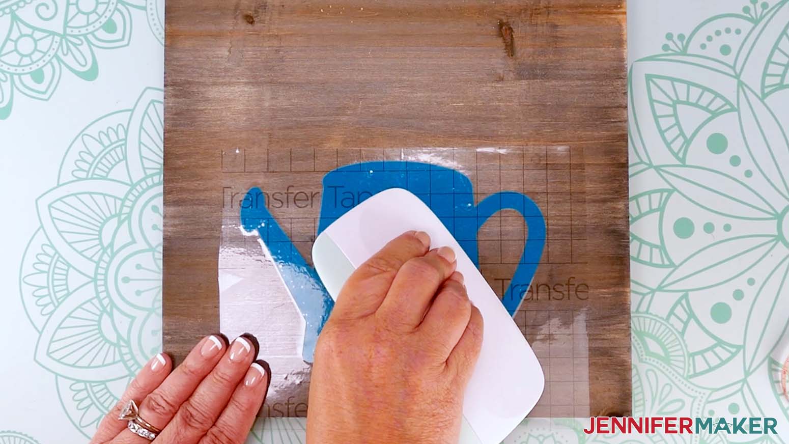 Use a scraper to adhere the vinyl to the wood sign.