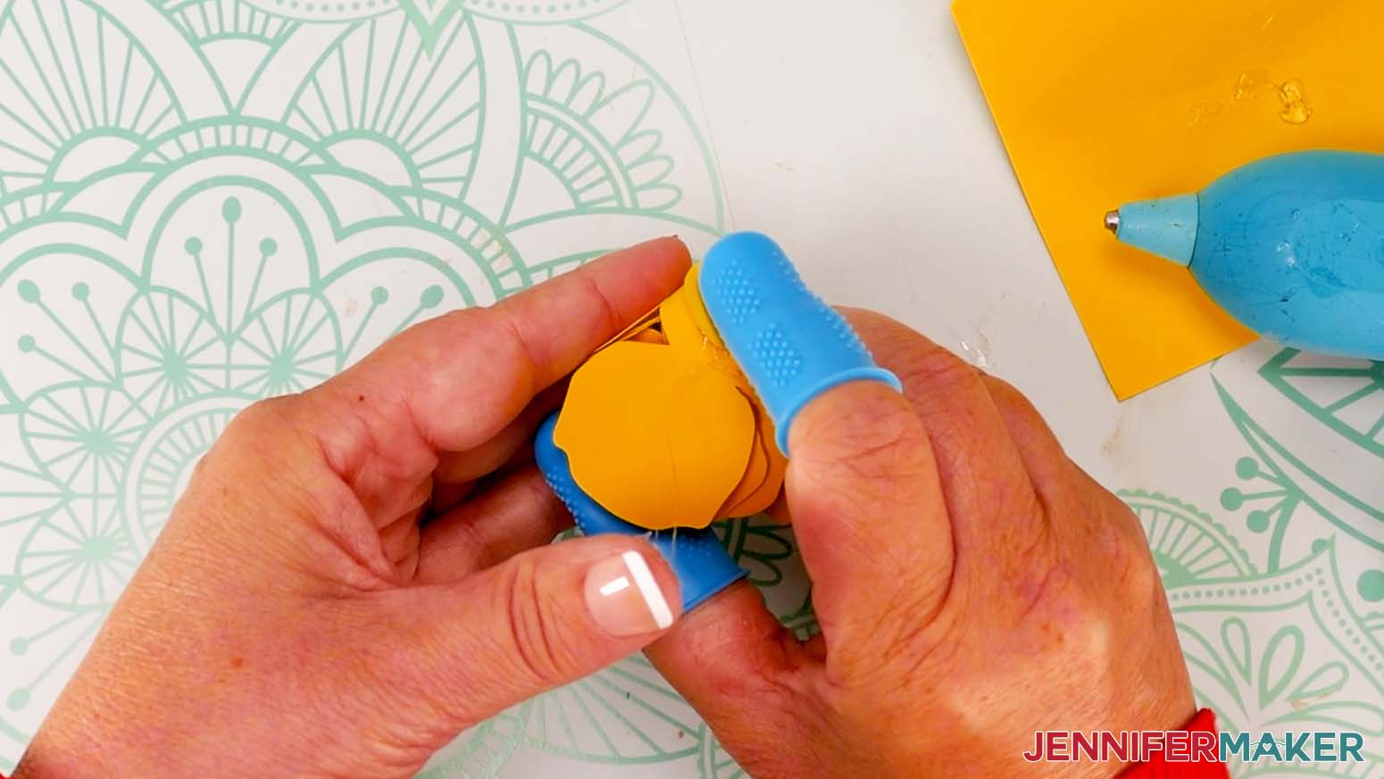 Add hot glue to the bottom tab of the rose and press it against the bototm of the flower.