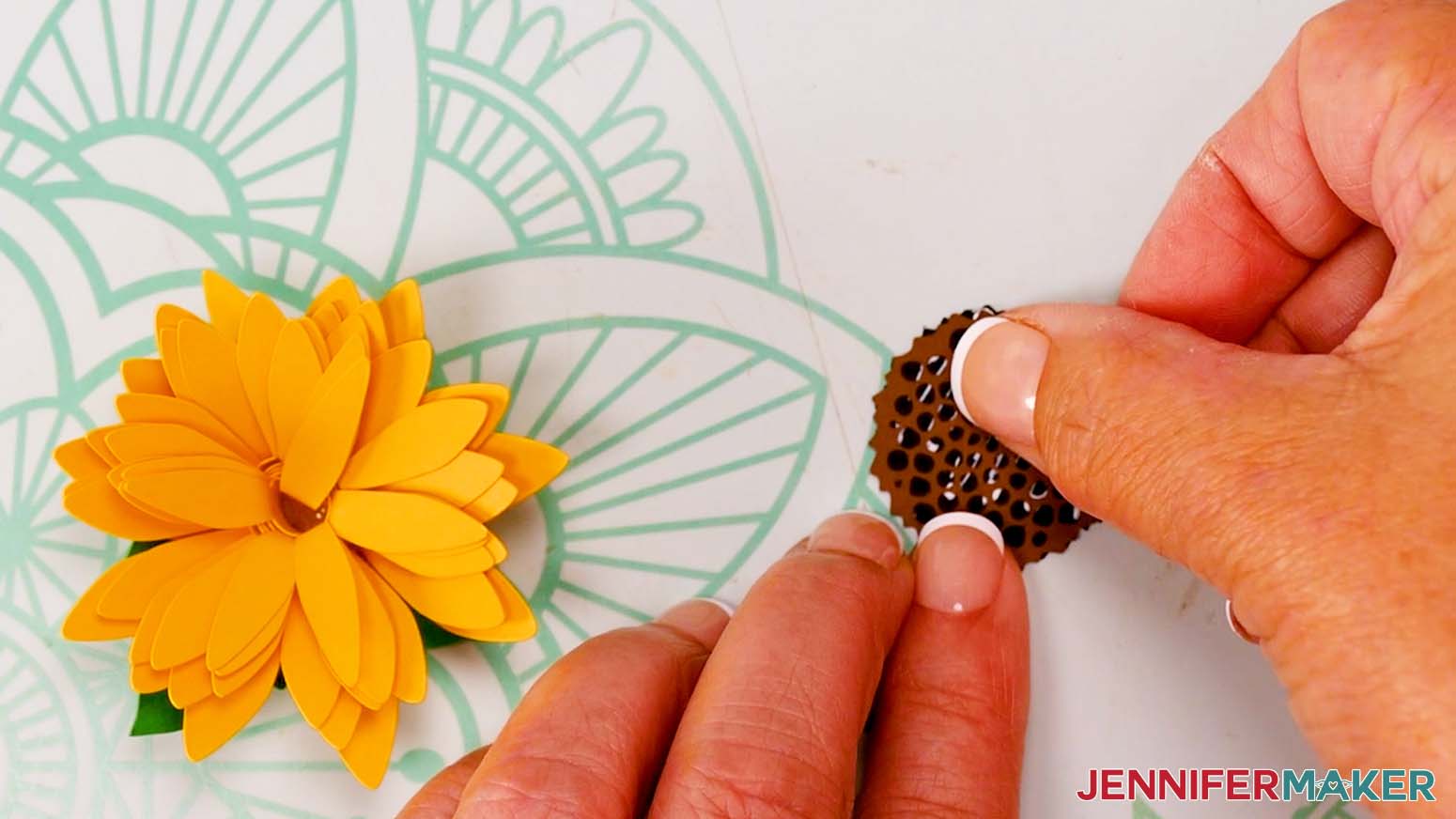 Use glue to attach the seed head layers of the sunflower.