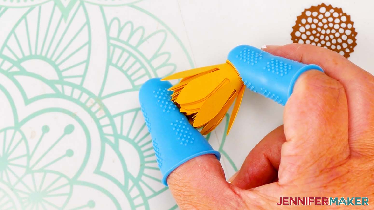 Press and hold the bottom of the flower for the glue to adhere.