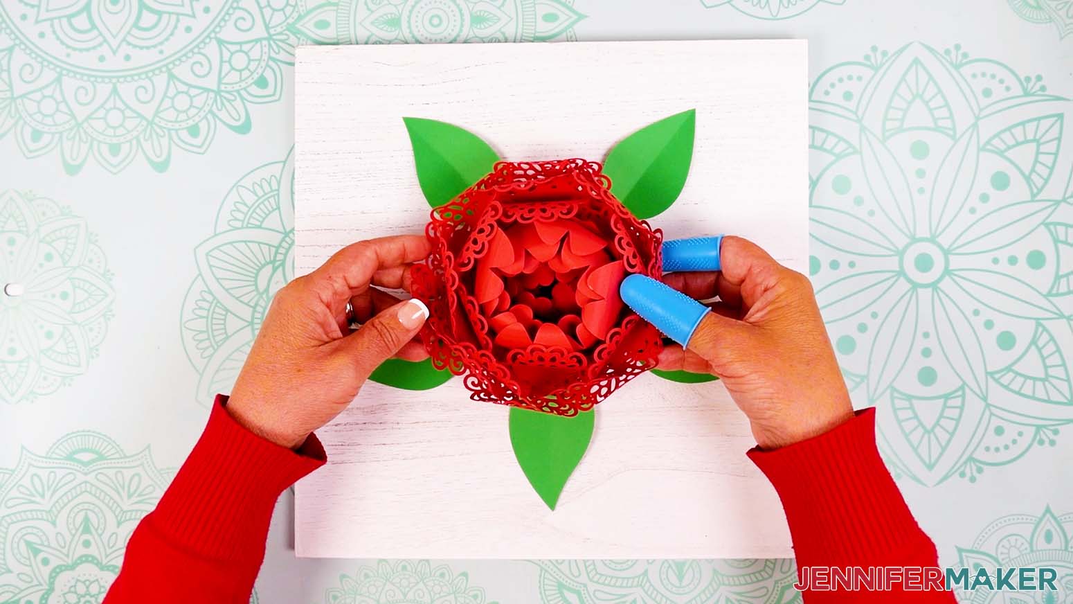 Press the assembled lacy flower onto the center of the sign, on top of the leaves.