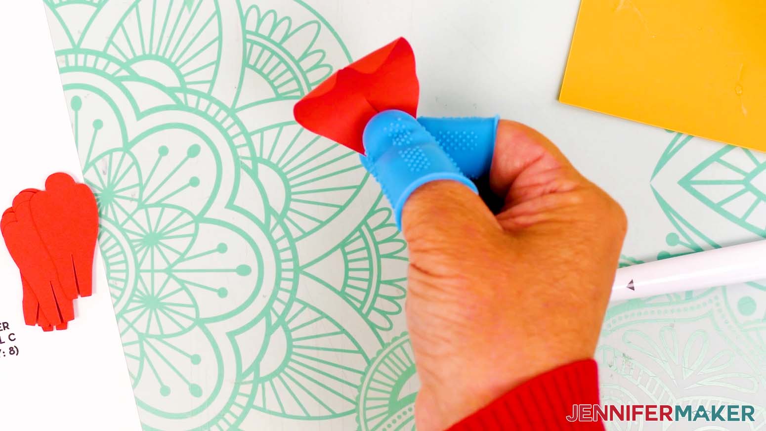Add a small dab of hot glue to one of the peony petal's tabs, then overlap it with the other tab.
