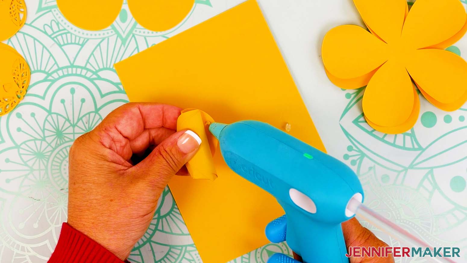 Use hot glue to secure the edges of the bud center.