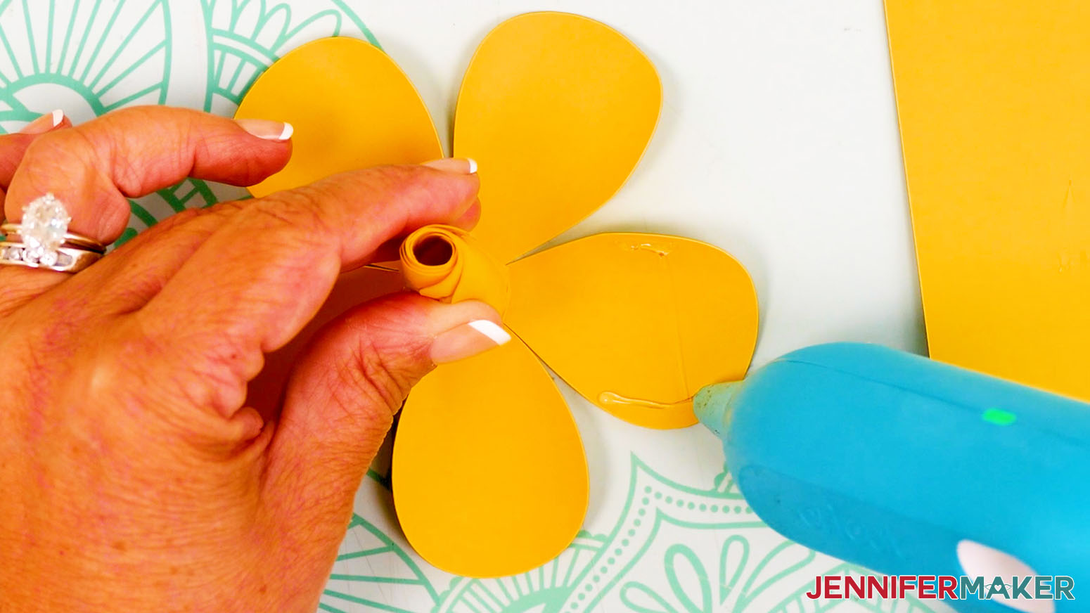 Apply hot glue to the side edges of the petals.