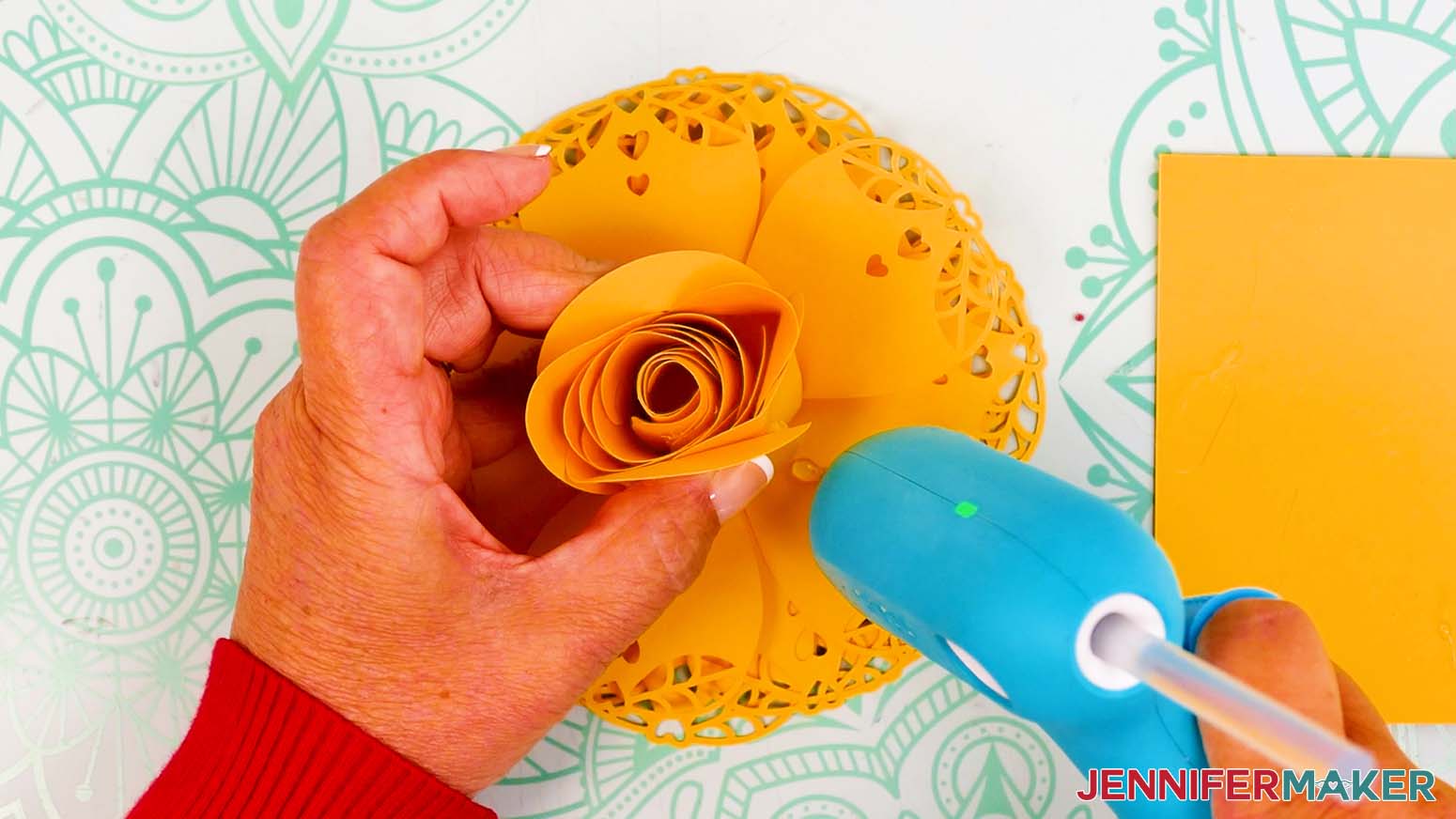Add hot glue at the bottom of the first lacy petal.