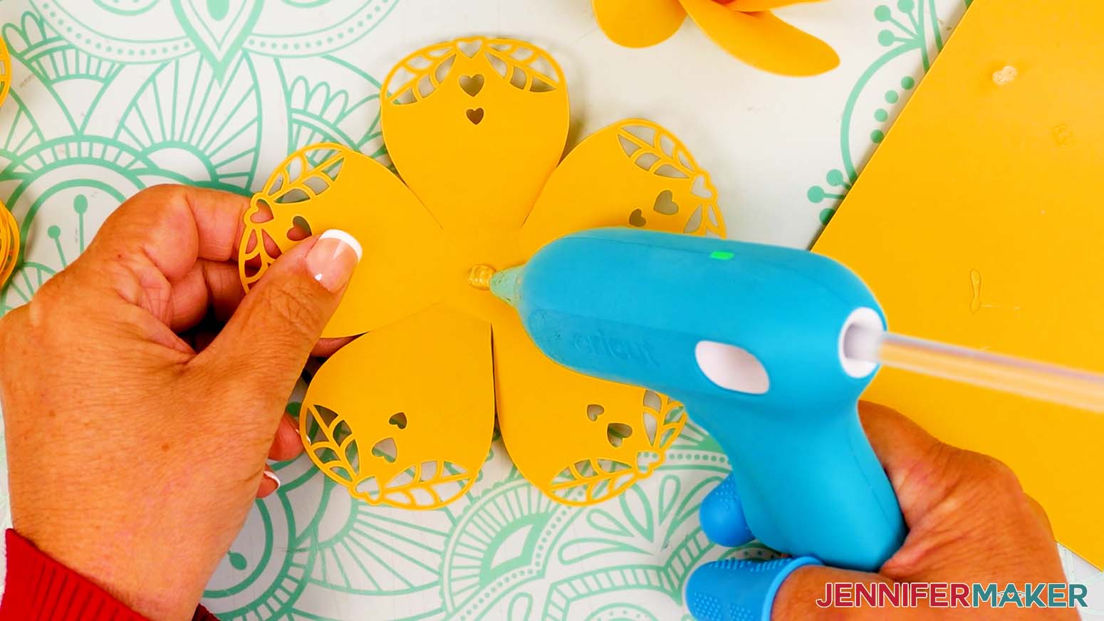 Place a dab of hot glue in the center of the first lacy petals piece.