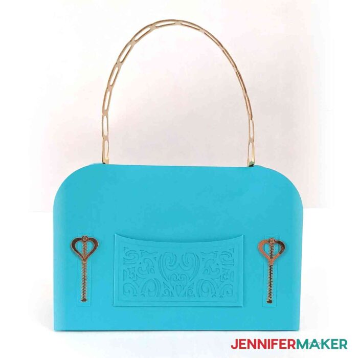 Couture paper handbag in blue cardstock with gold accents.