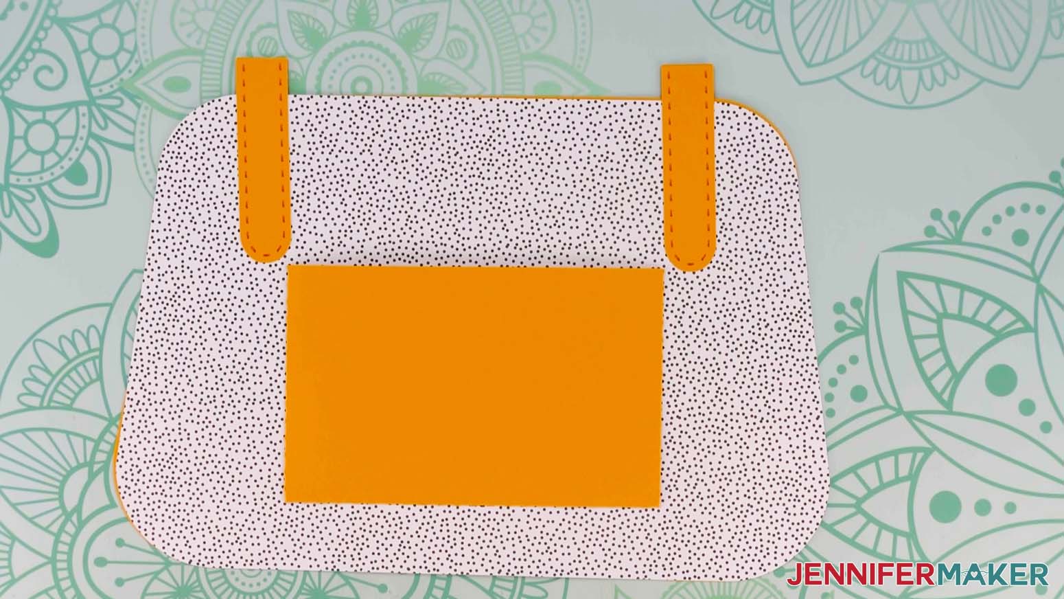 An overhead photo showing the inside of the Flower Power paper handbag with the short handle pieces and pocket attached