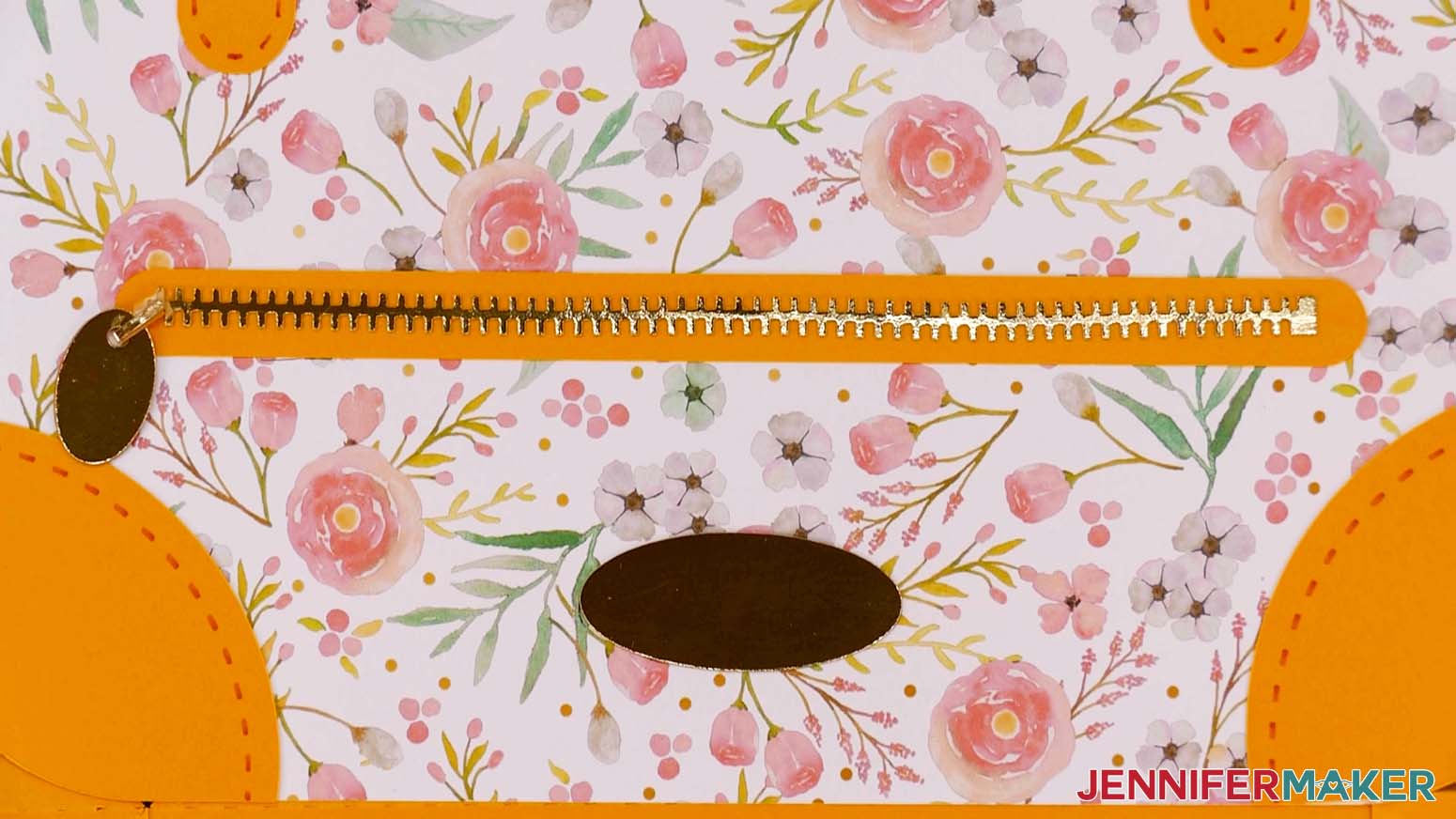 A closeup photo showing the zipper piece with zipper pull attached to the left end on the Flower Power paper handbag