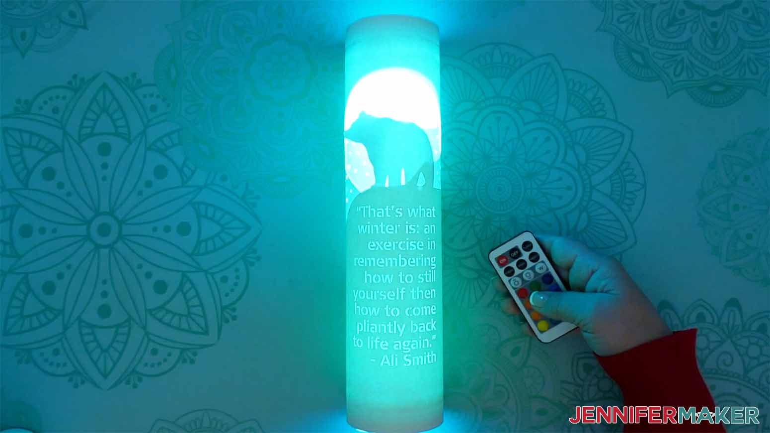 The finished bear paper lantern with lights lit up green.