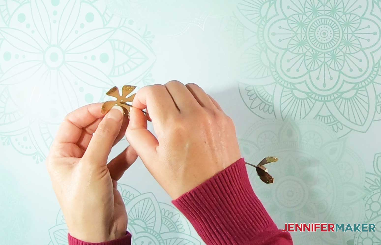 Thread paper pinecone scales onto stem