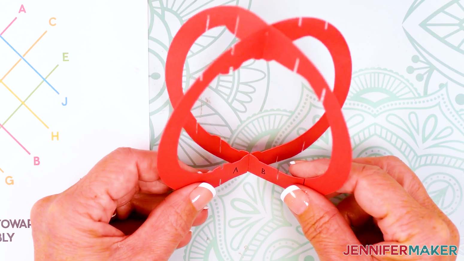 Insert paper pop up Easter Egg piece A into piece B at the top and bottom center slits to make an X shape.