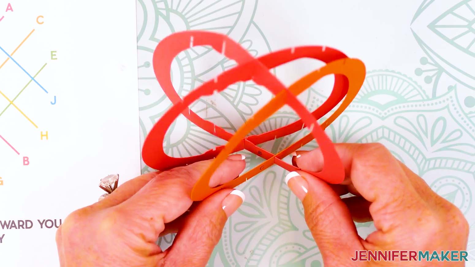Insert the bottom middle slit of piece C into the corresponding bottom slit on piece B.