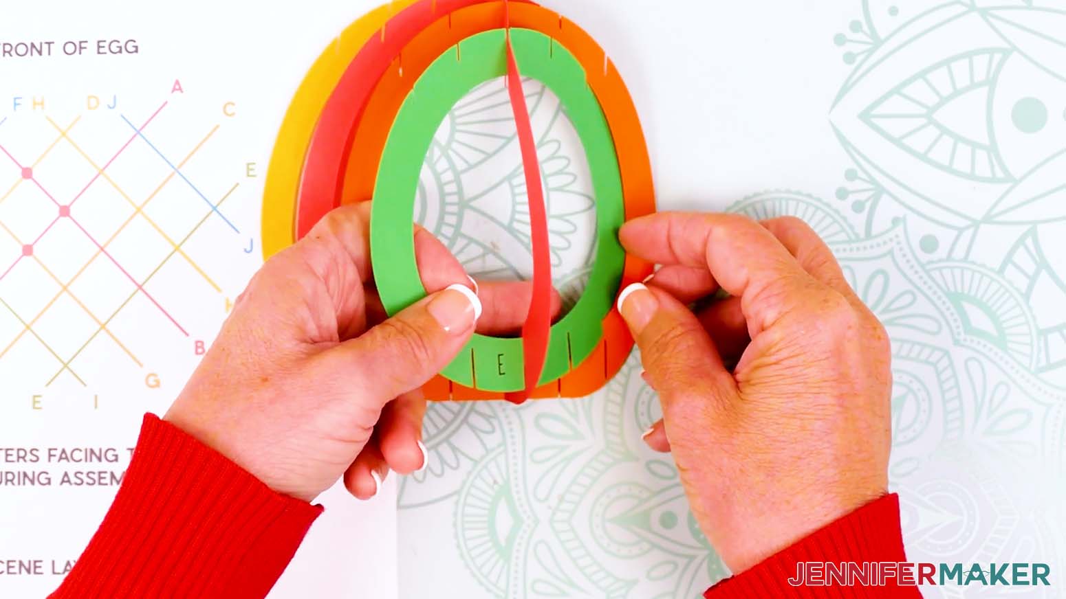 Insert the middle slits of piece E into the outer slits on piece B.