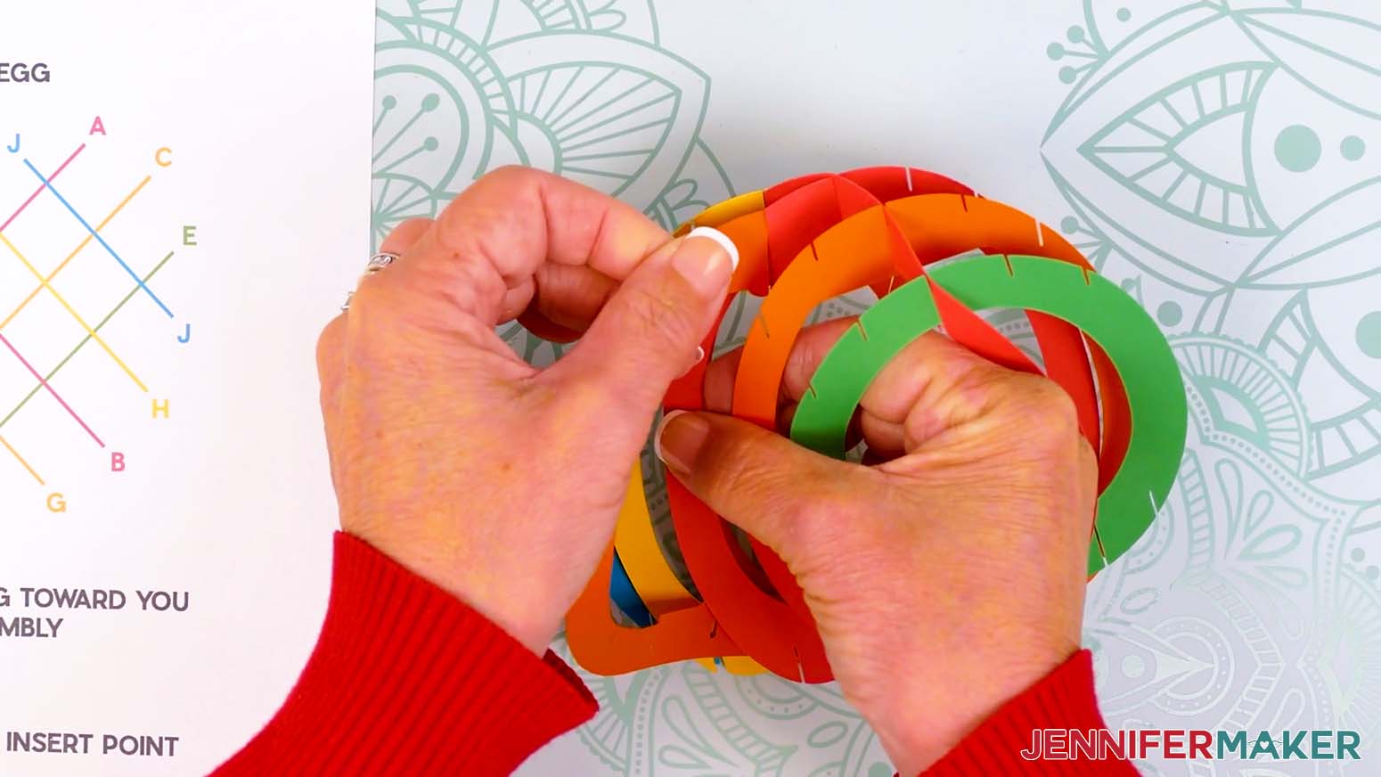 Insert the top middle slit of piece G into the corresponding top slit on piece A.