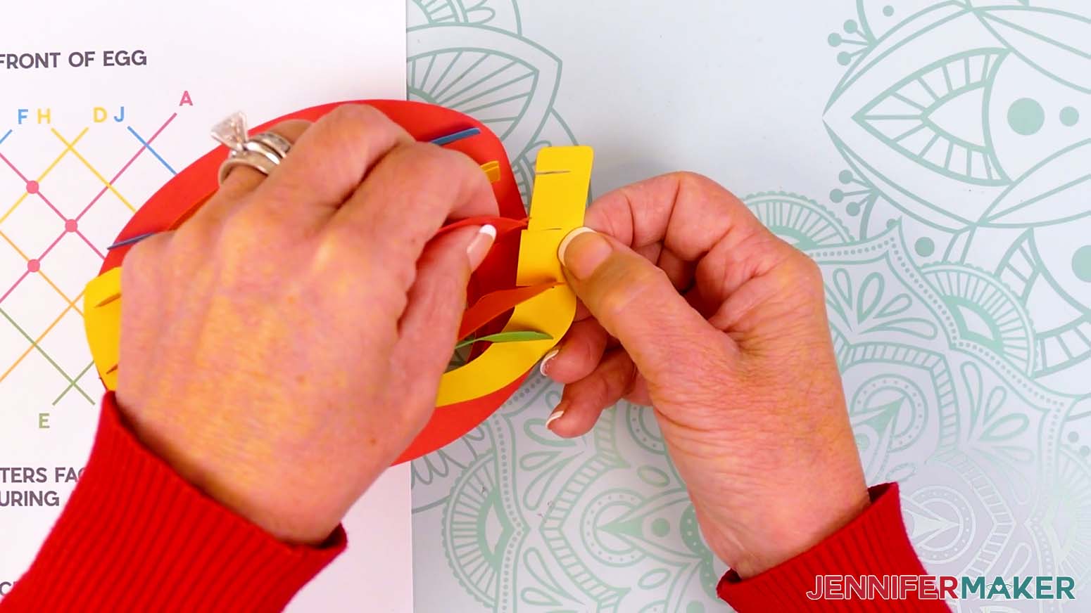 Insert the bottom slits of piece H into the bottom slits on pieces D, A, C, and E.
