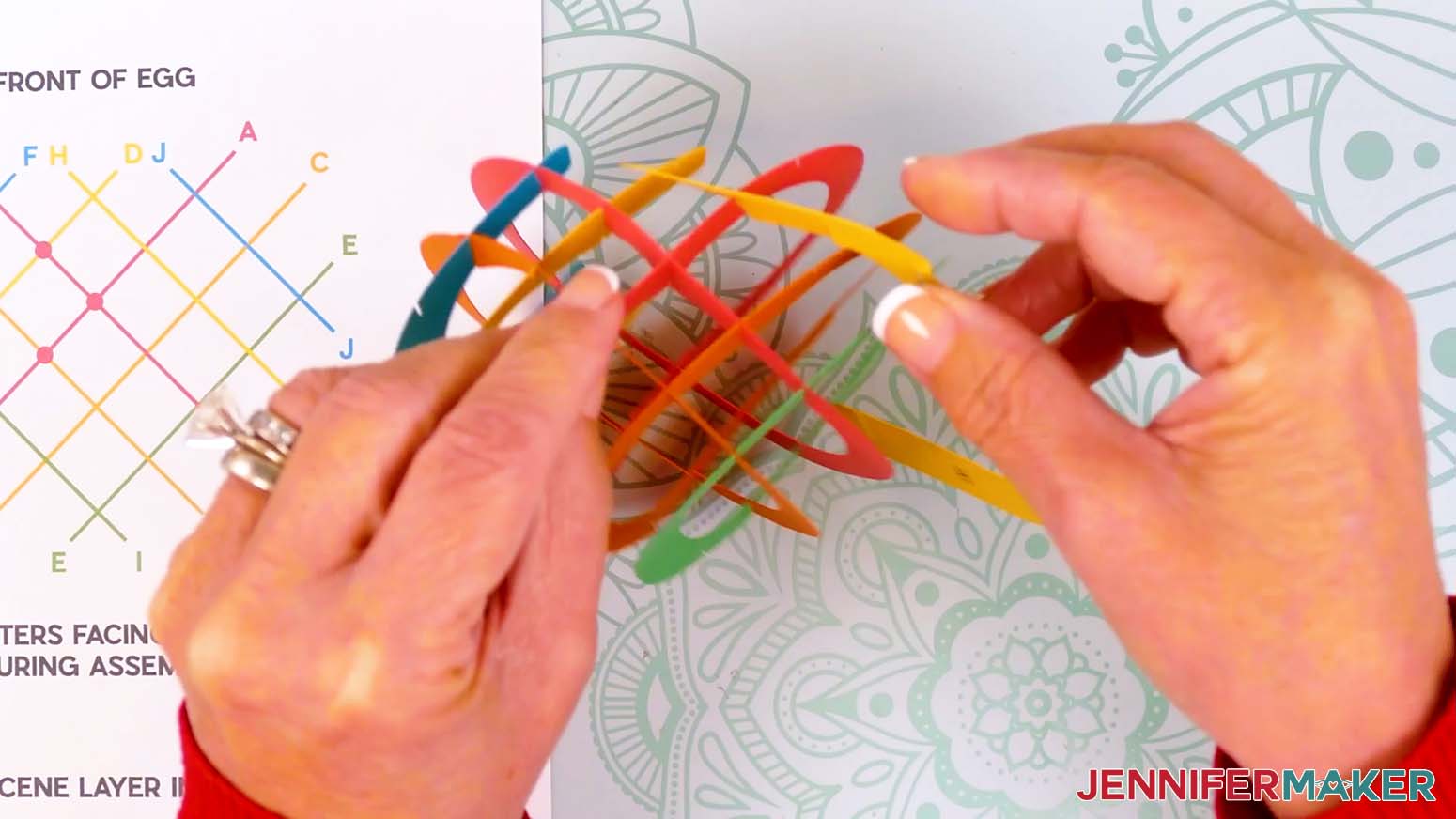 Insert the top slits of piece H into the top slits on pieces D, A, C, and E.