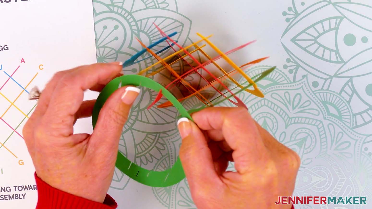 Insert the top middle slit of piece I into the top outer slit on piece A.