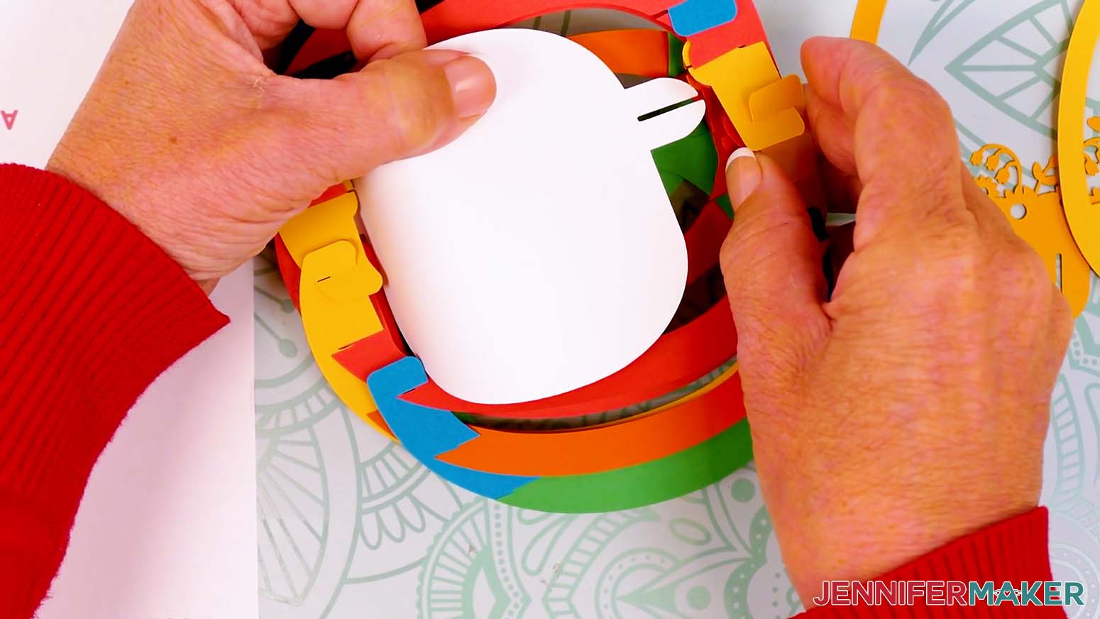 Flip the egg to insert the back scene layer's bottom tab into the paper pop up Easter egg's shell.
