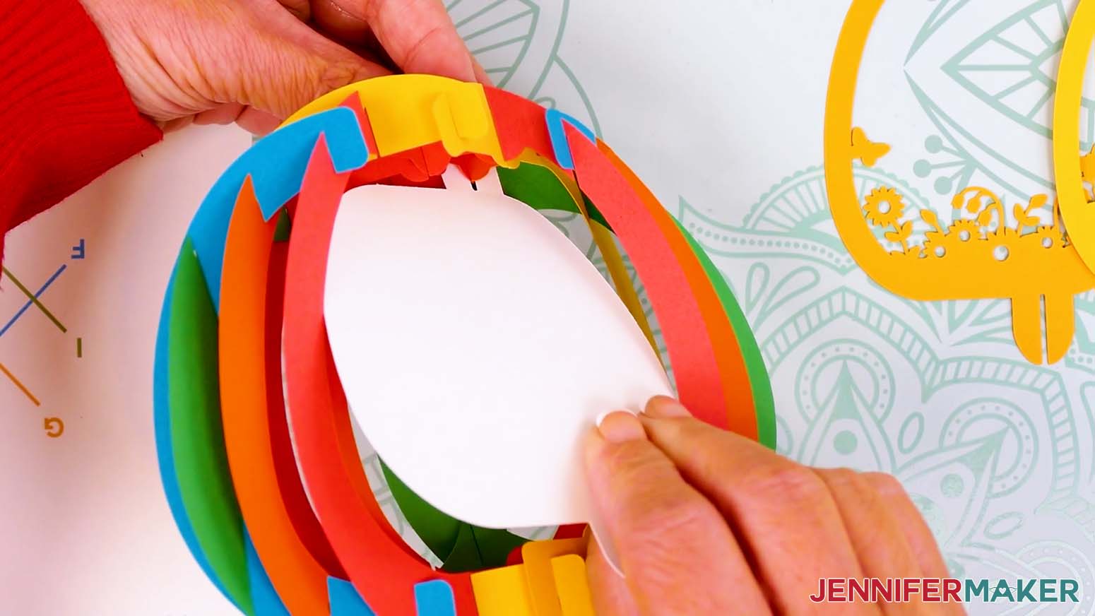 Insert the back scene layer's top tab into the top back bump of the paper pop up Easter egg's shell.