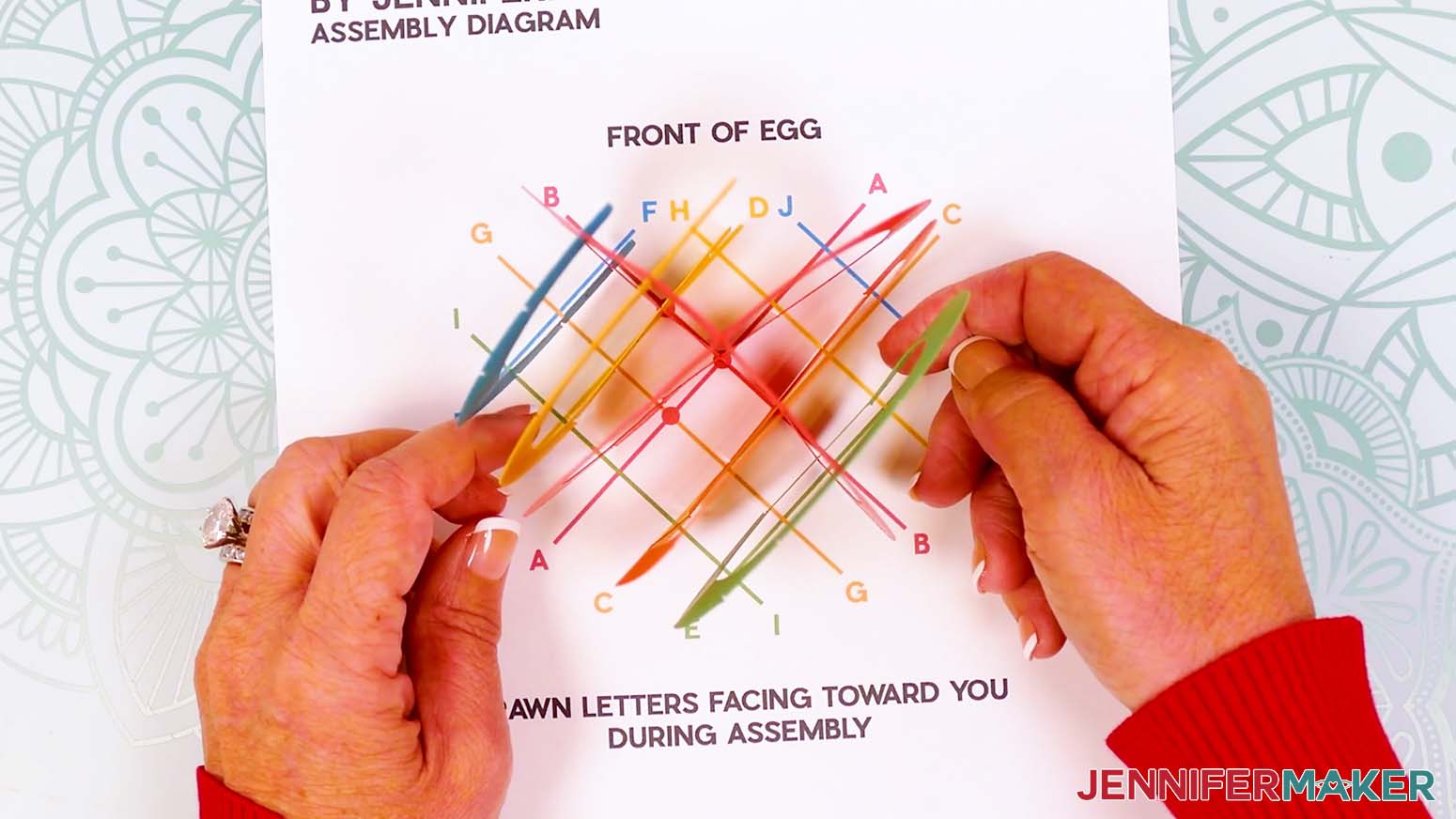 The first half of the paper pop up Easter egg assembled and placed on top of the printed assembly diagram.