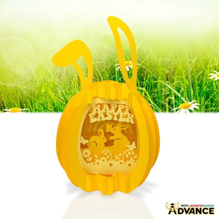 Paper Pop Up Easter Egg project on display, featuring yellow cardstock and an intricate bunny scenes customized with "Happy Easter" text